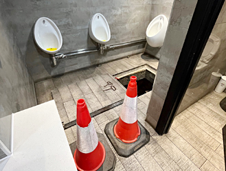 Internal manhole access inside a commercial property secured for safety.