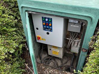 Outdoor pump control cabinet serviced and cleared of debris.