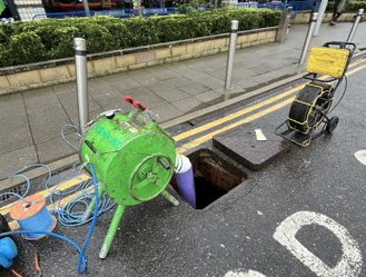 Relining machinery in operation as the new liner is fed into the damaged drain.