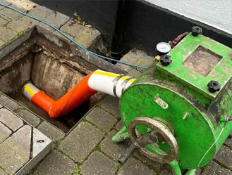 Another repair job in Greenwich, London: Drain relining equipment curing a new liner inside a residential pipe run.