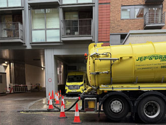 Jet and Drain vacuum tanker pumping waste from a block of flats sewage pump station in London.