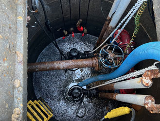 Jet and Drain vacuum tanker after completing waste removal from a sewage pump station tank, with the area left clean and operational.