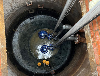 Jet and Drain technician repairing a sewage pump station pump system in London.