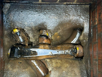 Removal of grease and waste buildup from a manhole chamber using specialist jetting equipment.